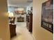 Inviting hallway leading to the living area with view of kitchen and decorative accents at 11875 Buck Creek Cir, Noblesville, IN 46060