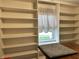Built-in bookshelves and a window make a great space for a reading nook at 11875 Buck Creek Cir, Noblesville, IN 46060