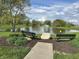 Picturesque pond view with benches, a water fountain, and lush greenery, perfect for relaxation at 11875 Buck Creek Cir, Noblesville, IN 46060