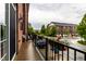 Balcony view of brick townhomes, well-maintained landscaping, and a glimpse of the neighborhood at 11905 Kelso Dr # 3, Zionsville, IN 46077