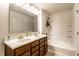 Bathroom featuring double vanity, framed mirror, garden tub, showerhead and white walls at 11905 Kelso Dr # 3, Zionsville, IN 46077