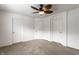 Carpeted bedroom featuring white walls, ceiling fan and three doors at 11905 Kelso Dr # 3, Zionsville, IN 46077