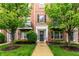 Charming brick townhome featuring a landscaped front yard and inviting entryway at 11905 Kelso Dr # 3, Zionsville, IN 46077