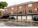 Brick townhome exterior featuring individual garages, personal balconies, and black iron railings at 11905 Kelso Dr # 3, Zionsville, IN 46077