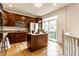 Well-lit kitchen with wooden cabinets, stainless steel appliances, and an island with granite countertops at 11905 Kelso Dr # 3, Zionsville, IN 46077