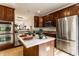 Bright eat-in kitchen with wood cabinets, stainless appliances, and a kitchen island at 11905 Kelso Dr # 3, Zionsville, IN 46077