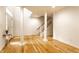 Bright living room with hardwood floors, columns, and staircase at 11905 Kelso Dr # 3, Zionsville, IN 46077