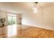 Spacious living room with hardwood floors, ample natural light, and modern light fixture at 11905 Kelso Dr # 3, Zionsville, IN 46077
