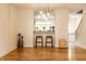Bright open-concept living room with wood floors and a pass-through to the eat-in kitchen at 11905 Kelso Dr # 3, Zionsville, IN 46077