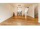 Bright open-concept living room with wood floors and a pass-through to the eat-in kitchen at 11905 Kelso Dr # 3, Zionsville, IN 46077