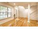 Bright living room with hardwood floors, columns, and view of staircase at 11905 Kelso Dr # 3, Zionsville, IN 46077