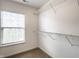 A walk-in closet featuring a window and wire shelving for optimal storage at 11905 Kelso Dr # 3, Zionsville, IN 46077