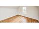 Bright bedroom features hardwood floors and a window overlooking the neighborhood at 1231 Nester St, Speedway, IN 46224