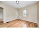 Bright bedroom featuring hardwood floors, neutral walls, and a window for natural light at 1231 Nester St, Speedway, IN 46224