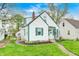 Charming two-story home with white siding, green trim, and a well-maintained lawn at 1231 Nester St, Speedway, IN 46224