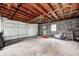 Spacious garage interior with white garage door, concrete floor, brick walls, and ample natural light at 1231 Nester St, Speedway, IN 46224