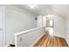 Upper hallway featuring hardwood floors and white walls providing access to bedrooms at 1231 Nester St, Speedway, IN 46224