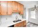 Well-lit kitchen featuring light countertops, stainless sink, and stylish wood cabinets at 1231 Nester St, Speedway, IN 46224