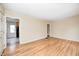 Inviting living room with gleaming hardwood floors and doorway leading to kitchen and hall at 1231 Nester St, Speedway, IN 46224