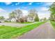 Street view of charming homes surrounded by lush trees and greenery, showcasing a peaceful neighborhood setting at 1231 Nester St, Speedway, IN 46224