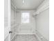 Bright walk-in closet with white wire shelving and a window for natural light, offering ample storage space at 1231 Nester St, Speedway, IN 46224