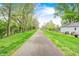 Scenic view of a paved walking path lined with trees and green grass, promoting an active lifestyle at 1231 Nester St, Speedway, IN 46224