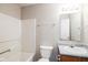 Bathroom featuring a shower-tub combo, sleek white fixtures, and a modern vanity at 12704 Bearsdale Dr, Indianapolis, IN 46235