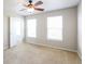 Bedroom with plush carpeting, bright windows and an inviting doorway at 12704 Bearsdale Dr, Indianapolis, IN 46235