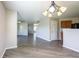 This dining area provides an open view of the living room, featuring new hardwood floors at 12704 Bearsdale Dr, Indianapolis, IN 46235