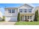 Charming two-story home featuring a well-manicured lawn, attached garage and inviting front porch at 12704 Bearsdale Dr, Indianapolis, IN 46235