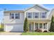 Traditional two-story home boasts green lawn, complementary landscaping, and an attached garage at 12704 Bearsdale Dr, Indianapolis, IN 46235