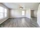 Spacious living room with durable gray flooring and abundant natural light from multiple windows at 12704 Bearsdale Dr, Indianapolis, IN 46235