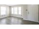 Bright living room with hardwood floors and big windows, creating a welcoming space to relax at 12704 Bearsdale Dr, Indianapolis, IN 46235