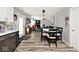 Open-concept dining room flows into living area with new floors, lots of light and eat-in kitchen at 12981 Coyote Run, Fishers, IN 46038