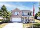 Charming two-story home featuring brick accents, a covered porch, and a well-manicured front yard at 12981 Coyote Run, Fishers, IN 46038