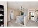Bright upstairs hallway featuring neutral paint, carpet, and two pendant lights at 12981 Coyote Run, Fishers, IN 46038