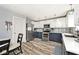 Well-lit kitchen with stainless steel appliances, white and navy cabinets and stylish backsplash at 12981 Coyote Run, Fishers, IN 46038