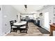 Open kitchen and dining area with wood floors, sleek cabinets, and modern lighting at 12981 Coyote Run, Fishers, IN 46038
