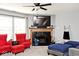 Cozy living room features a fireplace, comfortable seating, and a ceiling fan for added comfort at 12981 Coyote Run, Fishers, IN 46038