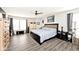 Spacious main bedroom with wood floors, ceiling fan and well-lit windows at 12981 Coyote Run, Fishers, IN 46038