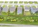An aerial view showcases a neat blue house with a well-maintained lawn and an outdoor patio at 1299 W Crystal Dr, Fortville, IN 46040