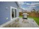 Outdoor patio area with a stainless-steel grill, sliding glass doors, and a fenced-in yard at 1299 W Crystal Dr, Fortville, IN 46040