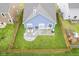 Aerial shot of a well-kept backyard featuring a cozy patio with seating and a fire pit at 1299 W Crystal Dr, Fortville, IN 46040