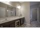 Bathroom featuring double sinks, a large mirror, and a walk-in shower at 1299 W Crystal Dr, Fortville, IN 46040