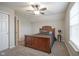 Comfortable bedroom featuring neutral walls, carpet flooring, and an elegant wooden bed frame at 1299 W Crystal Dr, Fortville, IN 46040