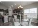 Dining area featuring hardwood floors, a modern chandelier, and view of the kitchen at 1299 W Crystal Dr, Fortville, IN 46040
