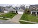 A charming gray brick home with neat landscaping and a pristine driveway creates a welcoming curb appeal at 1299 W Crystal Dr, Fortville, IN 46040