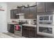 Well-equipped kitchen boasting stainless steel appliances, granite countertops, and ample dark wood cabinets at 1299 W Crystal Dr, Fortville, IN 46040