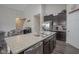 Kitchen island with stainless steel appliances, granite countertops, and dark cabinets at 1299 W Crystal Dr, Fortville, IN 46040