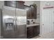 Modern kitchen featuring stainless steel appliances, granite countertops, and dark wood cabinetry at 1299 W Crystal Dr, Fortville, IN 46040